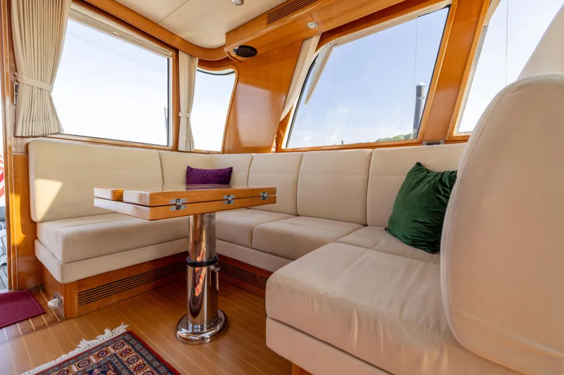 Slide: The Image of Luxurious interior of 2008 Grand Banks 45 Eastbay SX yacht with plush seating and wooden accents. - 17