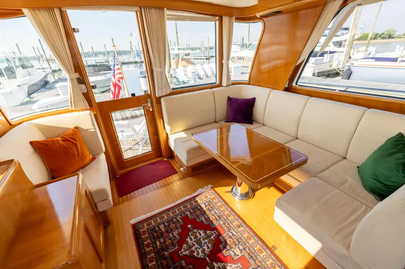 Slide: The Image of Interior of 2008 Grand Banks 45 Eastbay SX yacht with elegant seating and wooden table. - 23