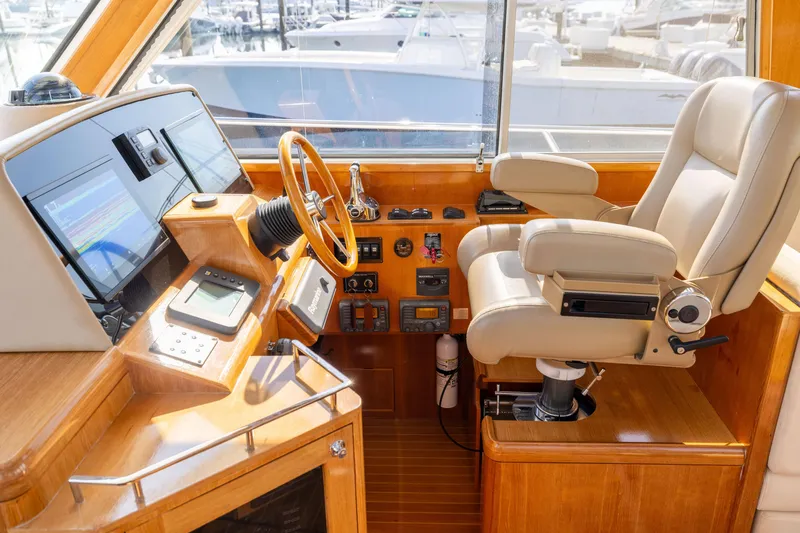 Slide: The Image of Luxurious helm of 2008 Grand Banks 45 Eastbay SX with leather captain's chair and advanced controls. - 25