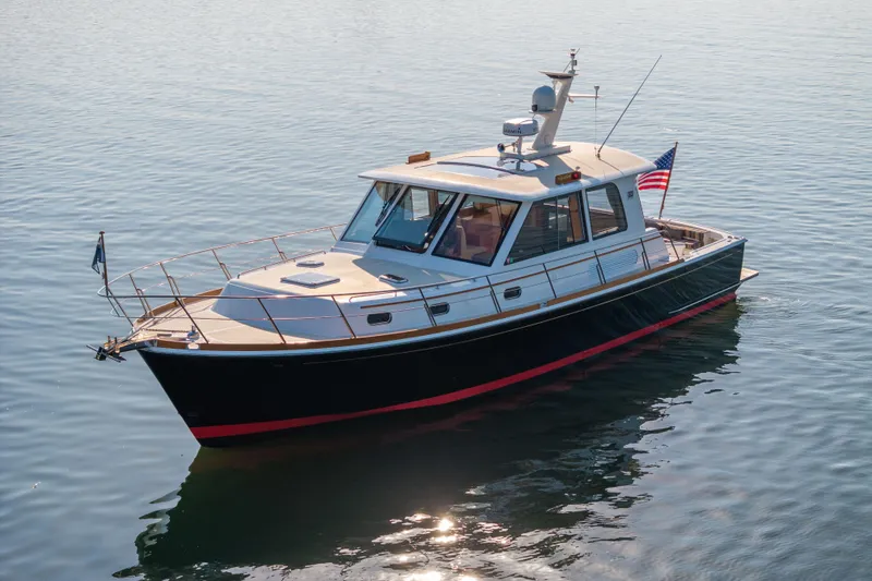 Slide: The Image of 2008 Grand Banks 45 Eastbay SX yacht cruising on calm waters with American flag. - 3