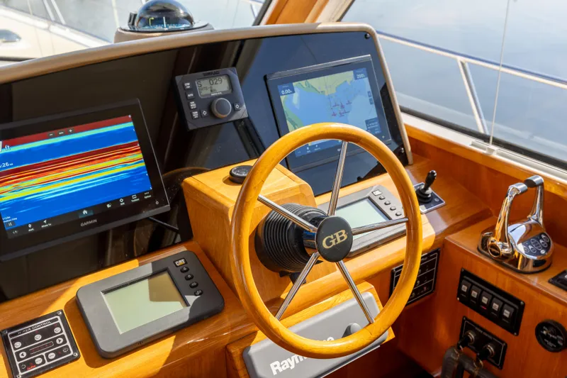 Slide: The Image of Helm of 2008 Grand Banks 45 Eastbay SX with navigation screens and wooden steering wheel. - 31