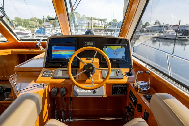 Slide: The Image of Helm of 2008 Grand Banks 45 Eastbay SX with navigation displays and wooden steering wheel. - 33