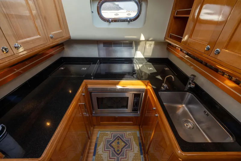Slide: The Image of Luxurious 2008 Grand Banks 45 Eastbay SX yacht kitchen with sleek countertops and modern appliances. - 37