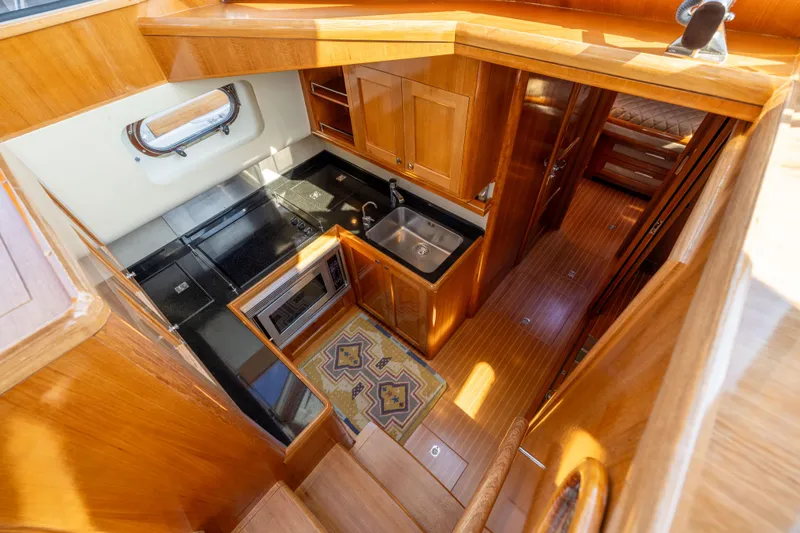 Slide: The Image of Luxurious 2008 Grand Banks 45 Eastbay SX yacht interior with modern kitchen and wooden finishes. - 39