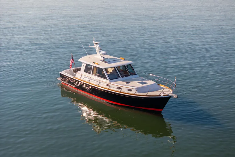 Slide: The Image of 2008 Grand Banks 45 Eastbay SX yacht on calm water, showcasing sleek design and elegance. - 4