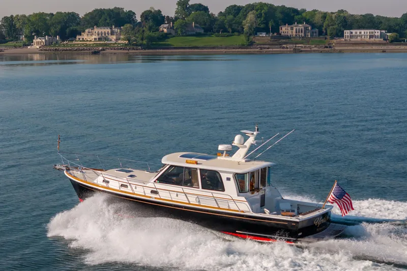 Slide: The Image of 2008 Grand Banks 45 Eastbay SX cruising on a scenic waterway with lush shoreline. - 5