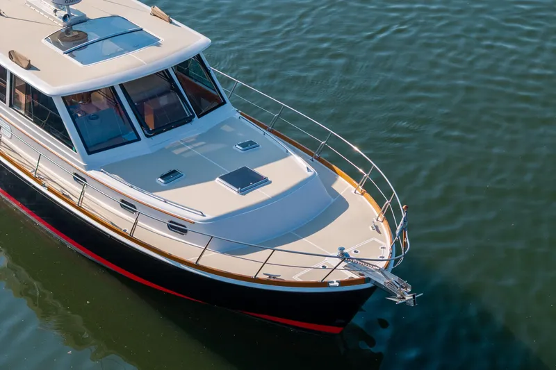 Slide: The Image of 2008 Grand Banks 45 Eastbay SX yacht on calm water, showcasing sleek design and craftsmanship. - 58