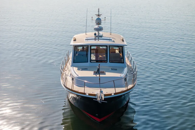 Slide: The Image of 2008 Grand Banks 45 Eastbay SX yacht on calm water, front view. - 59