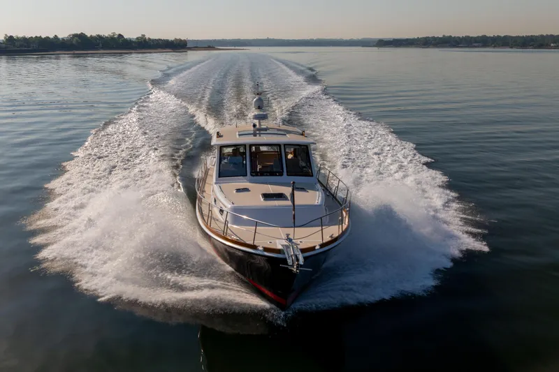 Slide: The Image of 2008 Grand Banks 45 Eastbay SX cruising on calm waters, creating a dynamic wake. - 60