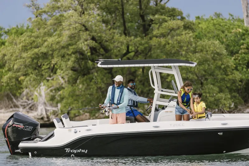 Slide: The Image of Manufacturer Provided Image: 2025 Bayliner Trophy T20CC boat with people fishing, cruising on a calm lake. - 2