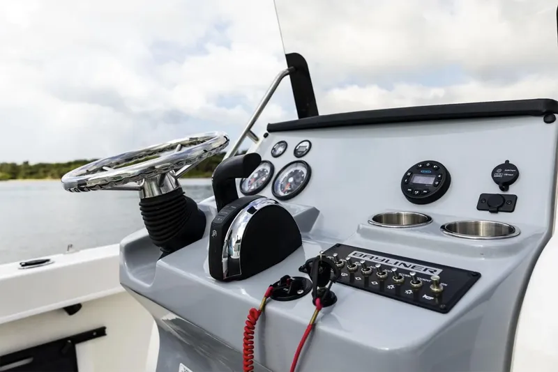 Slide: The Image of Manufacturer Provided Image: 2025 Bayliner Trophy T20CC boat dashboard with steering wheel and control panel. - 5