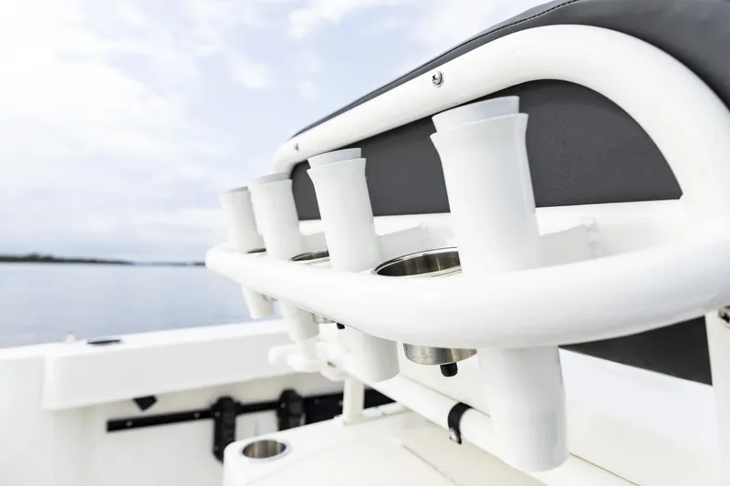 Slide: The Image of Manufacturer Provided Image: 2025 Bayliner Trophy T20CC boat with rod holders, on a calm water backdrop. - 6