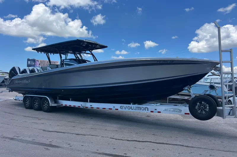 Slide: The Image of 2022 Nor-Tech 390 Sport Center Console boat on trailer under blue sky. - 1