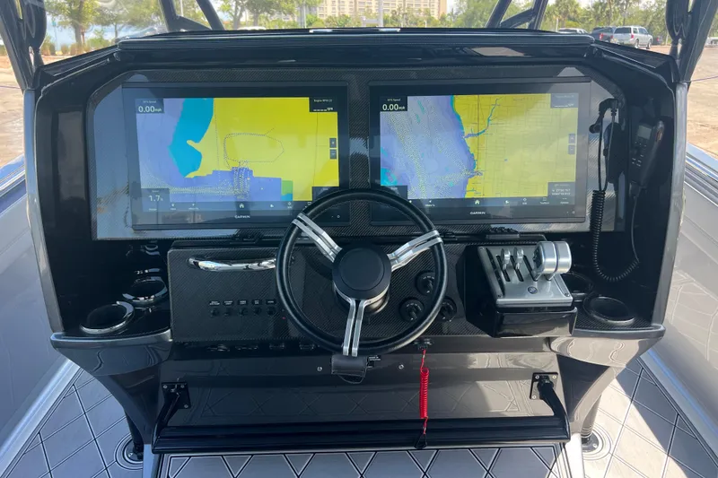 Slide: The Image of 2022 Nor-Tech 390 Sport Center Console dashboard with dual navigation screens and steering wheel. - 10