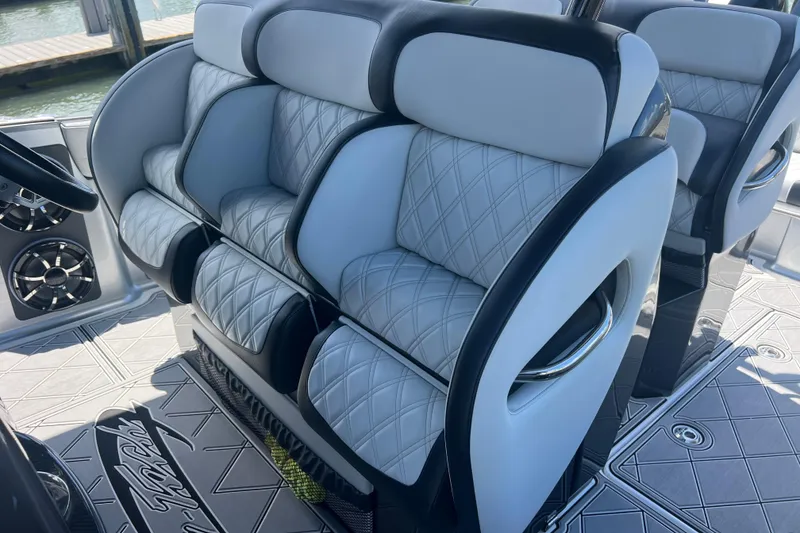 Slide: The Image of Luxurious seating on 2022 Nor-Tech 390 Sport Center Console boat, featuring quilted upholstery. - 14