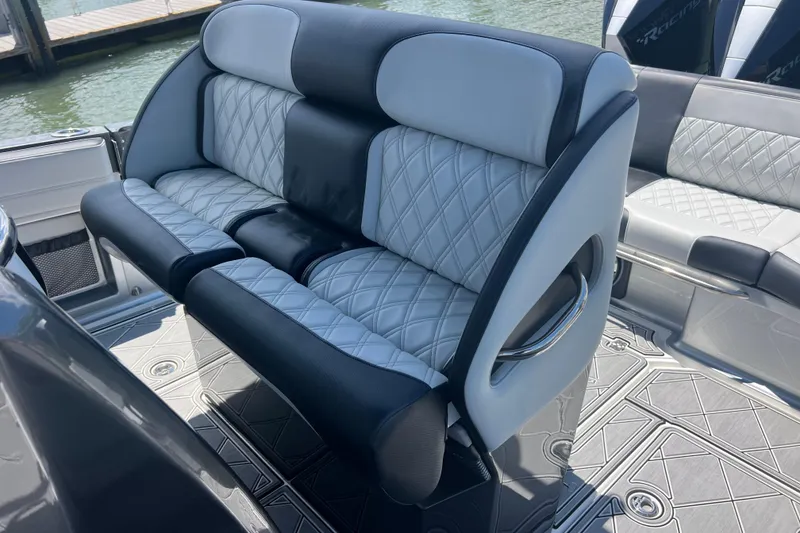 Slide: The Image of Luxurious seating on 2022 Nor-Tech 390 Sport Center Console boat, featuring quilted upholstery. - 15