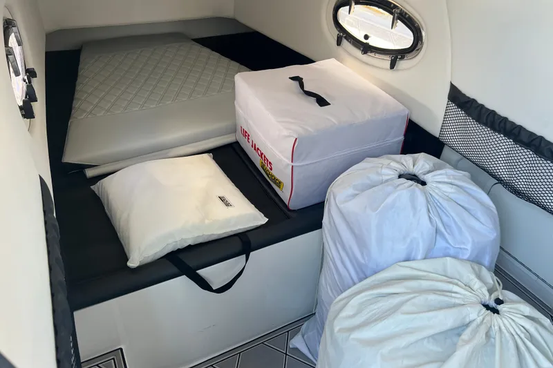 Slide: The Image of Interior cabin of 2022 Nor-Tech 390 Sport Center Console with storage and bedding. - 18