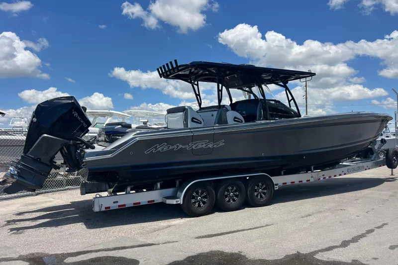 Slide: The Image of 2022 Nor-Tech 390 Sport Center Console boat on trailer under blue sky. - 3