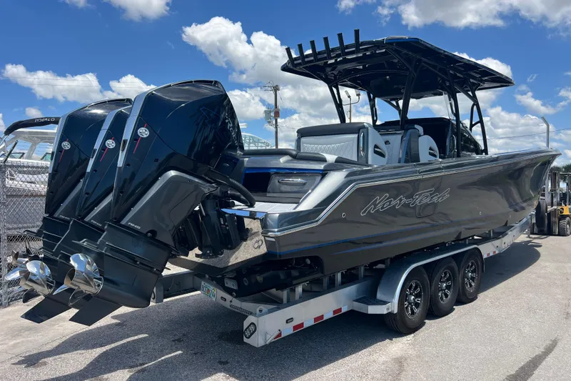 Slide: The Image of 2022 Nor-Tech 390 Sport Center Console boat with triple outboard engines on trailer. - 4