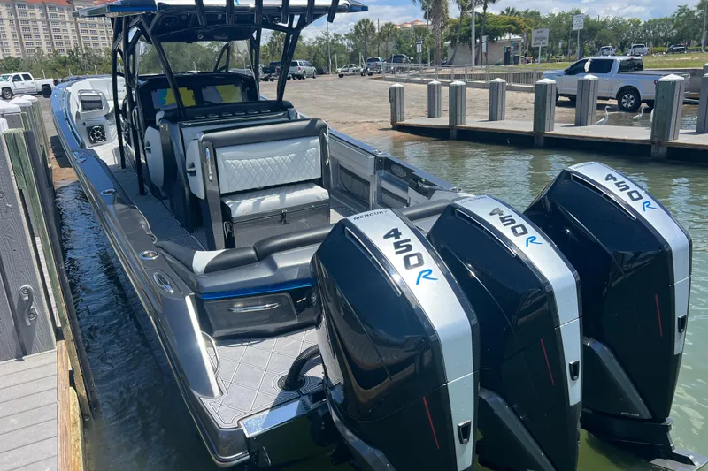 Slide: The Image of 2022 Nor-Tech 390 Sport Center Console boat with triple 450R Mercury engines docked. - 5