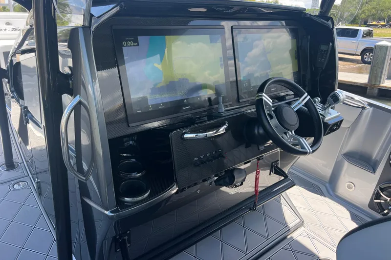 Slide: The Image of 2022 Nor-Tech 390 Sport Center Console helm with dual displays and modern steering wheel. - 9