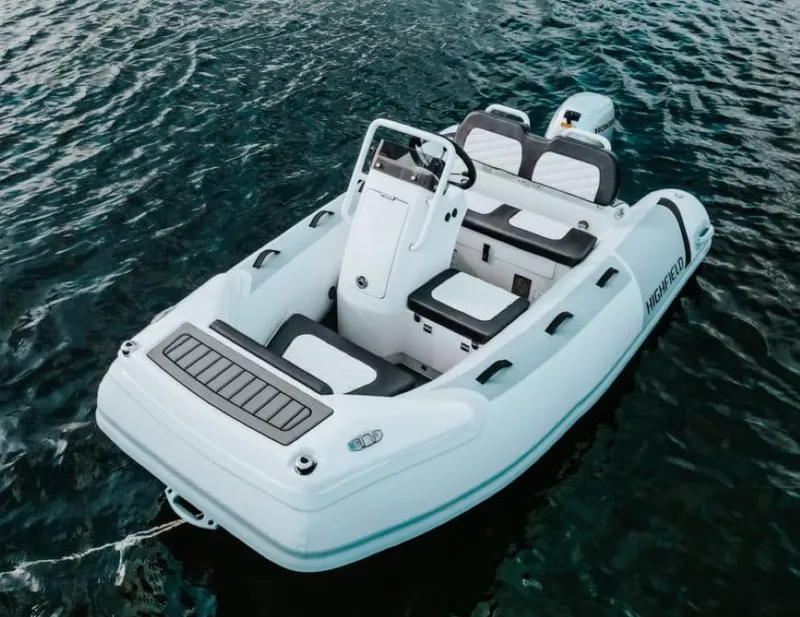 Slide: The Image of 2024 Highfield Sport 300 boat on water, white and grey design, modern seating. - 1