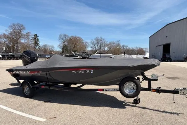 Slide: The Image of 2016 Tracker Pro Team 195 TXW Tournament Edition boat covered on trailer in parking lot. - 21