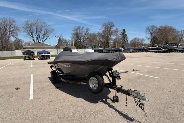 Slide: The Image of 2016 Tracker Pro Team 195 TXW Tournament Edition boat covered on trailer in parking lot. - 22