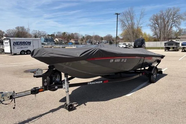 Slide: The Image of 2016 Tracker Pro Team 195 TXW Tournament Edition boat covered in a parking lot. - 24