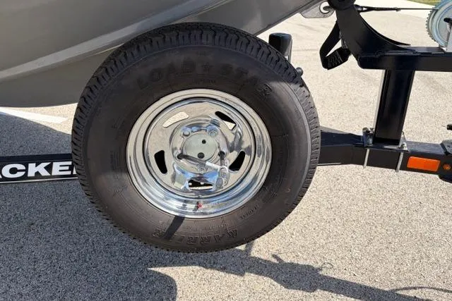 Slide: The Image of Trailer wheel of 2016 Tracker Pro Team 195 TXW Tournament Edition boat on pavement. - 4