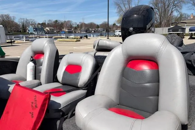 Slide: The Image of 2016 Tracker Pro Team 195 TXW Tournament Edition boat interior with gray and red seats. - 8