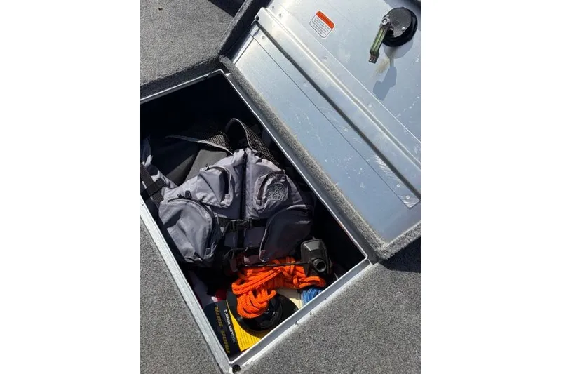 Slide: The Image of Storage compartment of 2016 Tracker Pro Team 195 TXW boat with gear and rope. - 9