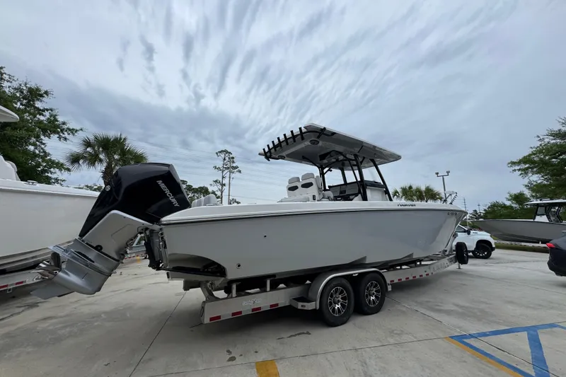 Slide: The Image of 2021 Fountain 34 Center Console boat on trailer, parked outdoors under cloudy sky. - 10