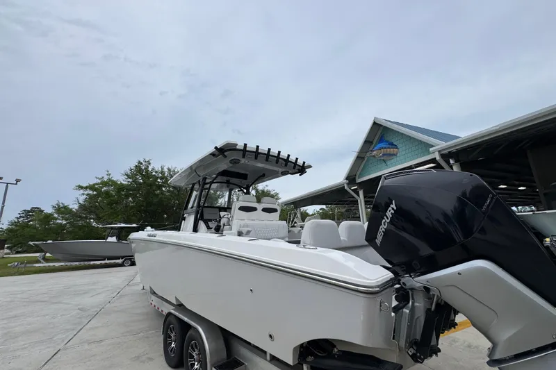 Slide: The Image of 2021 Fountain 34 Center Console boat with Mercury engine on trailer. - 13
