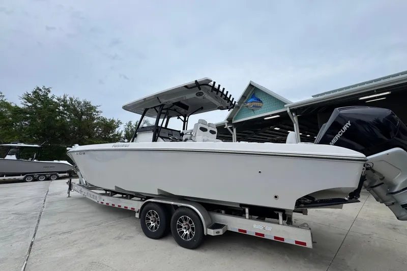 Slide: The Image of 2021 Fountain 34 Center Console boat on trailer, parked outdoors. - 14
