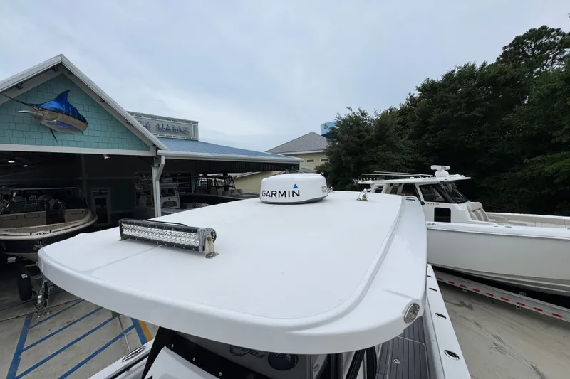 Slide: The Image of 2021 Fountain 34 Center Console boat with Garmin equipment at a marina. - 22