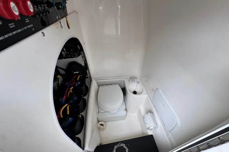 Slide: The Image of Interior of 2021 Fountain 34 Center Console boat with toilet and battery compartment. - 25
