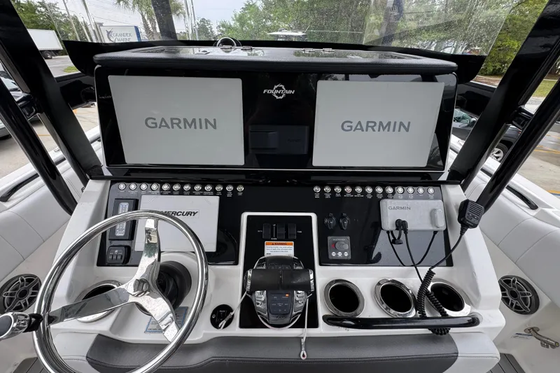 Slide: The Image of 2021 Fountain 34 Center Console boat dashboard with Garmin navigation displays. - 27