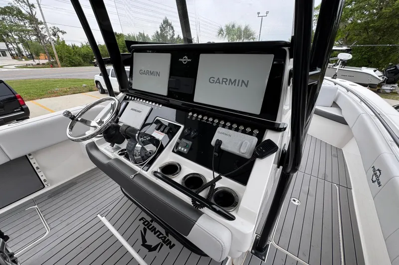 Slide: The Image of 2021 Fountain 34 Center Console boat dashboard with Garmin navigation displays. - 28