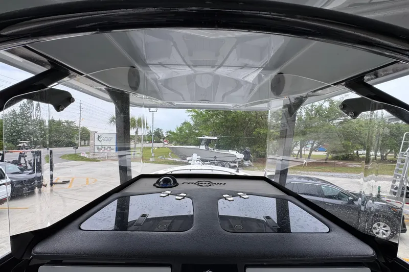 Slide: The Image of 2021 Fountain 34 Center Console boat interior view with clear canopy and dashboard. - 29