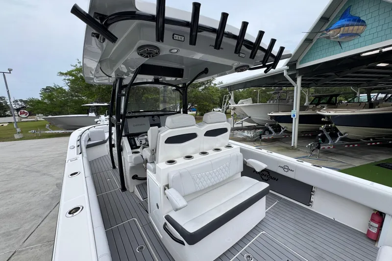 Slide: The Image of 2021 Fountain 34 Center Console boat with sleek seating and modern controls in a marina setting. - 33