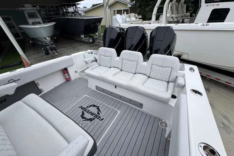 Slide: The Image of 2021 Fountain 34 Center Console boat with triple Mercury engines and luxurious seating. - 35