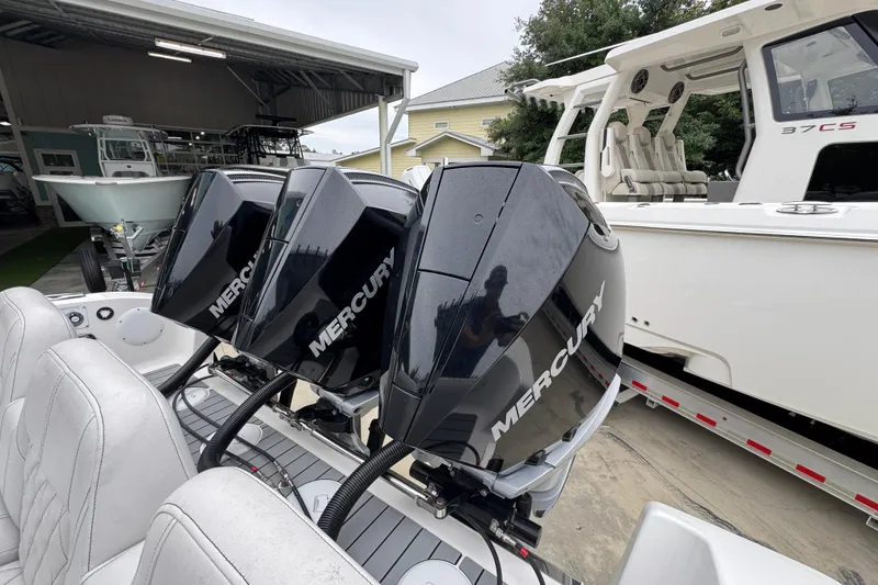 Slide: The Image of 2021 Fountain 34 Center Console with triple Mercury engines in a marina setting. - 38