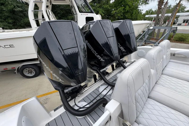 Slide: The Image of 2021 Fountain 34 Center Console with triple Mercury outboard engines and white seating. - 39
