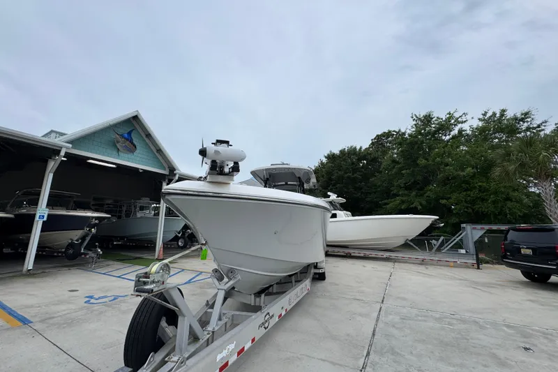 Slide: The Image of 2021 Fountain 34 Center Console boat on trailer at marina with other boats. - 5