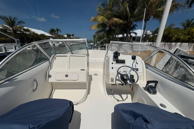 Slide: The Image of 2006 World Cat 250 DC boat interior with steering wheel, seats, and clear skies. - 4