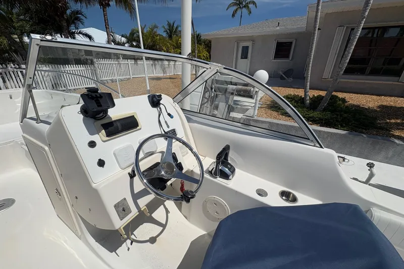 Slide: The Image of 2006 World Cat 250 DC boat cockpit with steering wheel and control panel. - 5