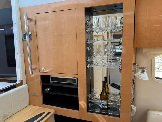 Slide: The Image of Interior of 2009 Four Winns V435 yacht with wine glasses and bottle. - 19