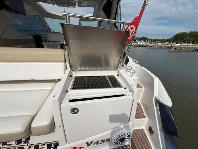 Slide: The Image of Grill on a 2009 Four Winns V435 yacht by the water. - 7