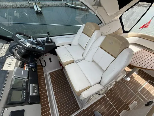Slide: The Image of Interior of a 2009 Four Winns V435 yacht with white leather seats. - 9
